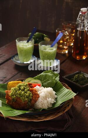 Ayam Geprek Andaliman. Fusion Street Food Gericht der Southern Fried Chicken gekrönt mit Sambal Andaliman, die grüne Chili und Andaliman Pfeffersoße. Stockfoto