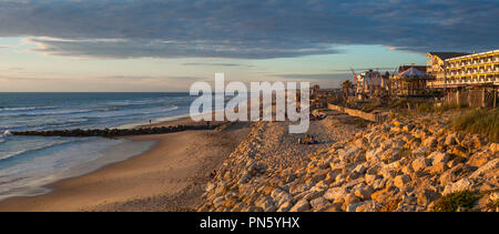 Lacanau-Ocean (Südwesten Frankreichs): Der Strand im Sommer, am Abend, mit Gebäuden am Wasser entlang, und die Verwendung von riprap Die coas zu schützen. Stockfoto