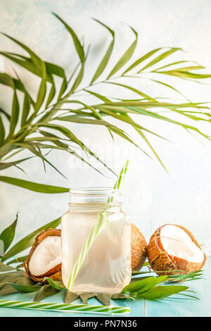 Kokosnuss Wasser und Kokosnüsse auf einem hellen Pastelltönen Hintergrund, selektive konzentrieren. Stockfoto