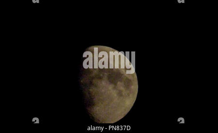 Whispers of the Moon: Eine himmlische Serenade, die im ätherischen Glanz des Halbmondes getaucht ist, entfaltet der Nachthimmel eine Geschichte des kosmischen Wunders. Stockfoto