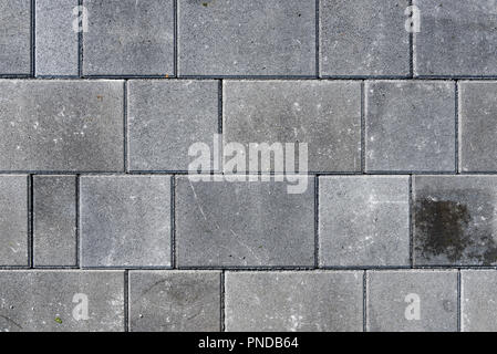 Beton oder Kopfsteinpflaster graue Pflaster Platten oder Steinen für Boden, Wand oder Pfad. Traditionelle Zaun, Gericht, Hinterhof oder Pflasterung der Straße. Stockfoto