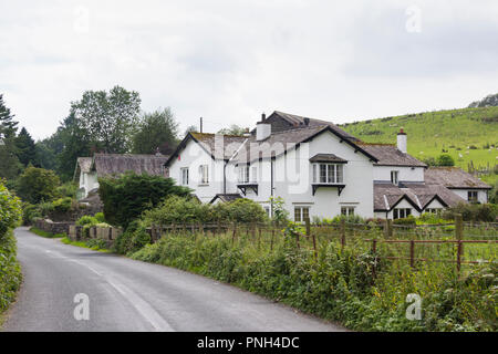 Große Häuser auf eine nicht klassifizierte Straße in einem ländlichen Teil des Lake District, weg von den beliebten Sehenswürdigkeiten um Windermere und Keswick. Stockfoto