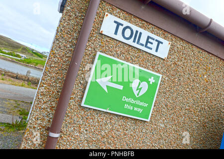 Defibrillator signage auf Wand außerhalb der öffentlichen Toiletten in Skeld Shetland Stockfoto