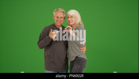 Frohes neues senior Eigenheimbesitzer mit Tasten Lächeln auf die Kamera auf Green Screen Stockfoto