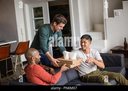 Männliche Freunde in Takeout Essen geliefert Stockfoto
