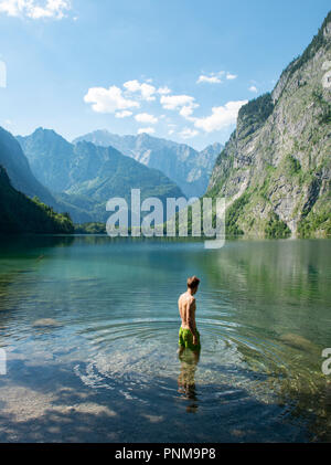 Junger Mann badet im Obersee, hinter dem Watzmannmassiv, Salet am Königssee, Nationalpark Berchtesgaden, Berchtesgadener Land Stockfoto