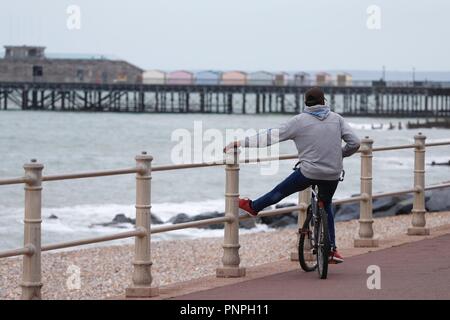 Hastings, East Sussex, UK. 22 Sep, 2018. UK Wetter: Herbstliches Wetter mit nur einer leichten Brise in der Luft und ruhige See, eine willkommene Rückkehr aus den vergangenen Tagen. Ein Mann auf einem Fahrrad bewundert, der Blick von der Promenade am Meer entfernt. © Paul Lawrenson 2018, Foto: Paul Lawrenson/Alamy leben Nachrichten Stockfoto