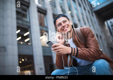 Mann Musik hören kopfhörer Konzept. Fröhlicher junger Kerl Hören der Musik. Stockfoto