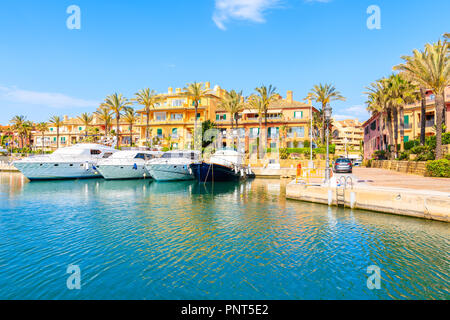 Segelboote im schönen Sotogrande Marina mit farbenfrohen Apartments und Palmen am Ufer, Costa del Sol, Spanien Stockfoto