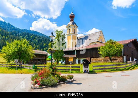 Kirche auf der grünen Wiese in Going am Wilden Kaiser Dorf auf sonnigen Sommertag, Tirol, Österreich Stockfoto