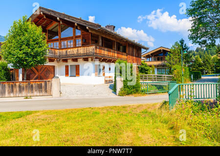 Traditionelle Häuser auf der grünen Wiese in Reith Bergdorf, Kitzbüheler Alpen, Österreich Stockfoto