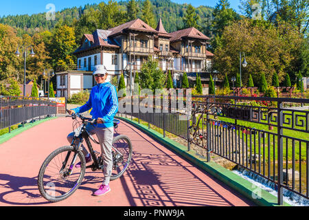 SZCZAWNICA, Polen - 19.September 2018: Junge Frau Radfahrer stehen auf Brücke in Szczawnica. Dieser Ort ist ein bekannter Ferienort ist berühmt für seine Gunst Stockfoto