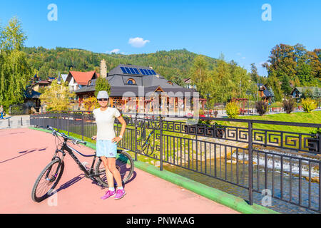 SZCZAWNICA, Polen - 19.September 2018: Junge Frau Radfahrer stehen auf Brücke in Szczawnica. Dieser Ort ist ein bekannter Ferienort ist berühmt für seine Gunst Stockfoto