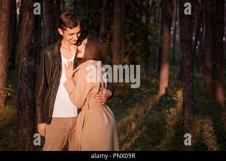 Junges Paar in Liebe umarmen im Herbst Wald. Der Mann und die Frau zu Fuß im Herbst Park Stockfoto