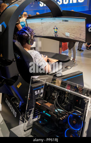 Besucher in Motorrad Fahrsimulator, der weltweit größten Messe für Computer- und Videospiele der Gamescom in Köln am 24.8.2018 Stockfoto