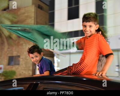 Riad, Saudi-Arabien. 23 Sep, 2018. Ein Junge Wellen eine nationale Flagge auf ein Auto der Nationale Tag in Riad, der Hauptstadt Saudi-Arabiens, Sept. 23, 2018 zu feiern. Saudi-arabien feierte seinen nationalen Tag an Sept. 23. Quelle: Tu Yifan/Xinhua/Alamy leben Nachrichten Stockfoto