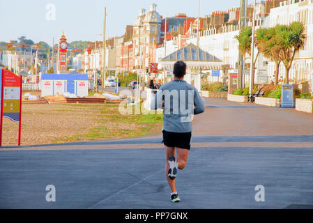 Weymouth. 24. September 2018. UK Wetter: ein Mann joggt entlang sonnigen Weymouth Beach, gut vor acht Uhr morgens Credit: stuart Hartmut Ost/Alamy leben Nachrichten Stockfoto