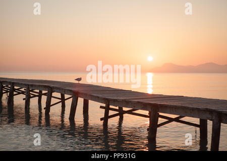 Europa Spanien Nord Mallorca Playa de Muro, langer Holzsteg in der Bucht von Alcudia bei Sonnenaufgang Stockfoto