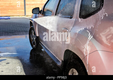 Autoreinigung unter hohem Druck mit Wasser und Shampoo in Nahaufnahme Stockfoto