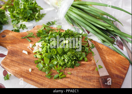 Grüne Kräuter. Frisch gehackte Petersilie, Dill und Frühlingszwiebeln. Stockfoto