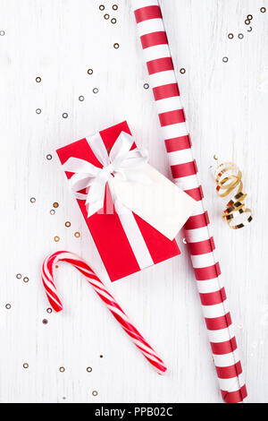 Weihnachten Geschenk verpackt in rotem Papier mit weißem Band auf weißem Hintergrund mit Holz dekoriert funkelt gebunden. Flach, kopieren. Stockfoto