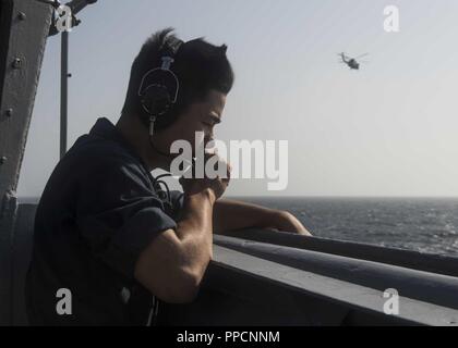 Golf von Aden (Sept. 3, 2018) - seaman Apprentice Luis Jiangli steht Lookout auf der Steuerbordseite der Brücke Flügel der Whidbey Island-Klasse dock Landung Schiff USS Rushmore (LSD 47), die während einer planmäßigen Einsatz der Essex Amphibious Ready Group (ARG) und 13th Marine Expeditionary Unit (MEU). Das Essex ARG/13 MEU ist tödlich, flexibel, und anhaltende Navy-Marine Corps Team in die USA 5 Flotte Bereich der Maßnahmen zur Unterstützung der Marine im Einsatz für die Stabilität und Sicherheit in der Region zu gewährleisten, Anschluss an das Mittelmeer und den Pazifischen Raum durch den westlichen Stockfoto