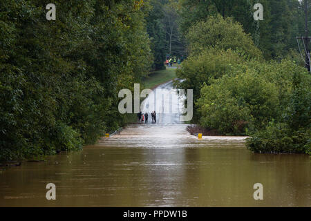 Waxhaw, North Carolina- September 16, 2018: Bewohner prüfen eine Straße durch Regen vom Hurrikan Florence überflutet Stockfoto