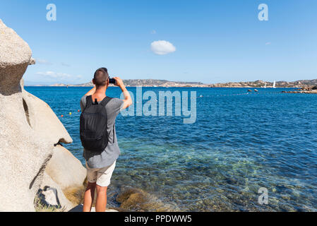 Jungen kaukasischen Mann ein Foto von der Küste des Mittelmeers in Sardinien, Italien, La Maddalena, Caprera, Santo Stefano und Isla Stockfoto