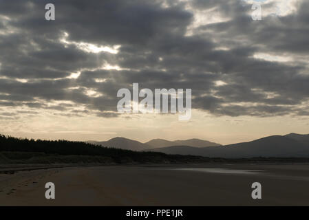 Blick von llanddwyn Island (ynys Llanddwynn), Anglesey, Nordwales, über den Strand bei Ebbe zu Snowdonia Mountains im Morgenlicht Stockfoto