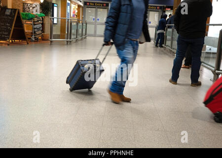 Ein Passagier zu Fuß durch den Flughafen nach der Ankunft am internationalen Flughafen Manchester T1 Ankunftshalle Stockfoto