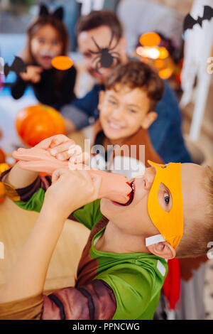 Cute boy tragen Ninja Turtle Kostüm für Halloween Streiche spielen Süßigkeiten essen Stockfoto