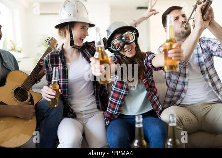 Eine Gruppe von Freunden, Gitarre zu spielen und Party zu Hause Stockfoto