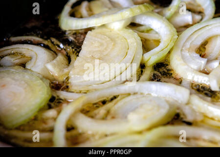 Gebratenen Zwiebeln in der Pfanne. Die Röstung der gehackte Zwiebel in Öl. Stockfoto