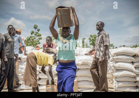 Uganda. 7. Mai, 2018. Eine der Südsudanesische weibliche Flüchtlinge gesehen, die Palmöl auf dem Kopf, als sie diese Versorgung mit Nahrungsmitteln durch das Welternährungsprogramm gegeben wurde. Die Bidi Bidi Flüchtling Siedlung im Norden Ugandas in der Nähe der sudanesischen Grenze ist derzeit das größte Flüchtlingslager der Welt, Hosting über 250.000 sudanesische Flüchtlinge im Süden des Konflikts. Das Welternährungsprogramm ist die Bereitstellung von monatlichen grundlegende Lebensmittel für die Flüchtlinge in der Siedlung. Credit: Alda Tsang/SOPA Images/ZUMA Draht/Alamy leben Nachrichten Stockfoto