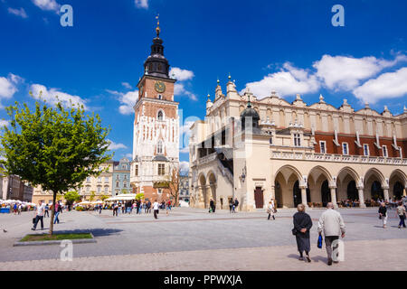 Krakau, Polen: Leute geht auf die Tuchhallen Gebäude und Altes Rathaus Turm in der Mitte der Hauptmarkt in der Krakauer Altstadt ( Stockfoto