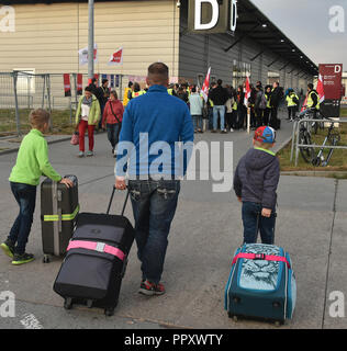 28. September 2018, Brandenburg, Schönefeld: Passagiere (vorn) gehen Sie in Richtung der Stürmer am Flughafen Schönefeld. Die Piloten und Flugbegleiter der irischen Gesellschaft Ryanair fliegt in den Streik gehen. Als Vorsichtsmaßnahme, Ryanair hat bis zu 195 Europäischen stornierte Flüge. Fast 48 Flüge wurden in Schönefeld abgebrochen. Foto: Bernd Settnik/dpa-Zentralbild/dpa Stockfoto