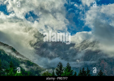 Dramatische Wolken vor berg Stockfoto