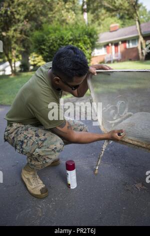 Us Marine Corps Cpl. Vannak Pen eine Marine Corps Combat Engineer bei der Bekämpfung der Logistik Bataillon 6 von Camp Lejeune, N.C., entfernt die Farbe von einem Stuhl während der Woche in Charlotte, N.C., Sept. 5, 2018. Marine Woche Charlotte ist eine Chance, unsere Marines, Matrosen, Veteranen und deren Familien aus verschiedenen Generationen zu verbinden. Stockfoto