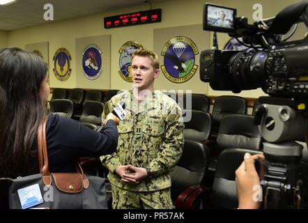 ANDERSEN AIR FORCE BASE, Guam - US Navy Lieutenant Ian McConnaughey, gemeinsame Region Marianas Public Affairs Officer, spricht mit Carmen Terlaje, ein Reporter für KUAM-TV nach Abschluss der Pressekonferenz auf Übung Valiant Shield, Sept. 17. Führungskräfte der Übung Valiant Shield sprach mit Mitgliedern der Medien heute von Andersen Air Force Base in der Start der Übung. Valiant Shield, einem US-amerikanischen Joint Force Übung mit Luft und Meer Vermögenswerte, Tests in Echtzeit Krieg kämpfen Fähigkeit in einem blauen Gewässer. Stockfoto