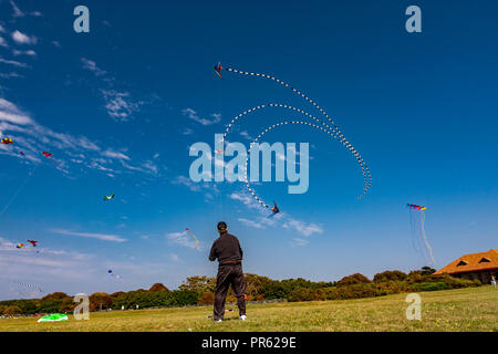 Mann in einem Feld flying a Kite Stockfoto