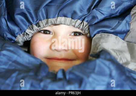 Junge gemütlich in einem Schlafsack Stockfoto