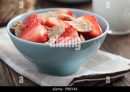 Frühstück mit Roggen- flocken und Erdbeere in eine blaue Schale Stockfoto