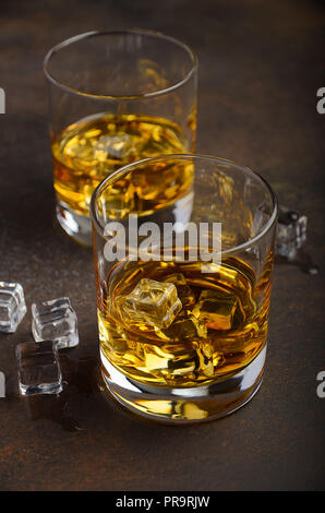 Glas Whisky mit Eis auf dem alten rostigen Hintergrund Stockfoto