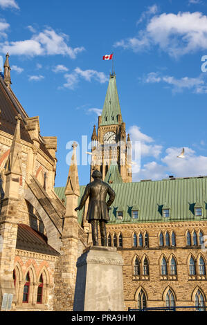 OTTAWA, Kanada - 5. Mai 2018: Parliament Hill Center Gebäude, Bibliothek und eine Statue. Parliament Hill ist ein Bereich der Krone Land auf der südlichen Ba Stockfoto