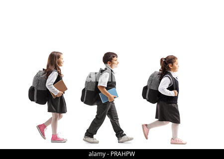 Volle Länge Profil Aufnahme von Schulkindern auf weißem Hintergrund zu Fuß Stockfoto