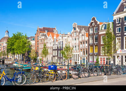 Amsterdam Häuser und Fahrräder auf Singel einer Gracht in Amsterdam Blauwburgwal Brücke über Singel Kanal Amsterdam Fahrrad hielten gegen Geländer Amsterdam EU Stockfoto