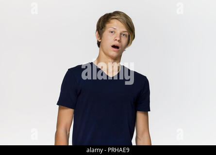 Portrait von überrascht und männliche Teenager mit geöffnetem Mund besorgt. Auf weissem Hintergrund Stockfoto