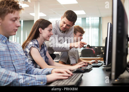 Lehrer helfen weiblichen High School Student in Computer Klasse Stockfoto