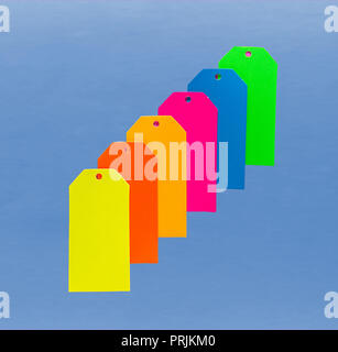 Sechs farbenfrohe Pappe Tags oben auf blauem Hintergrund Stockfoto