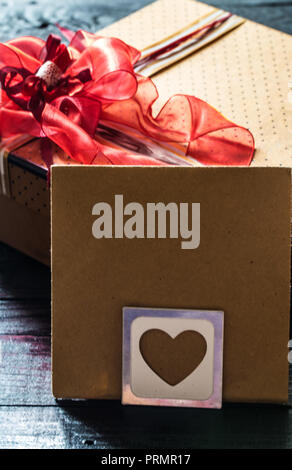 Der Umschlag am Valentinstag mit Herz, liegt auf Holz- Hintergrund, Konzept Stockfoto